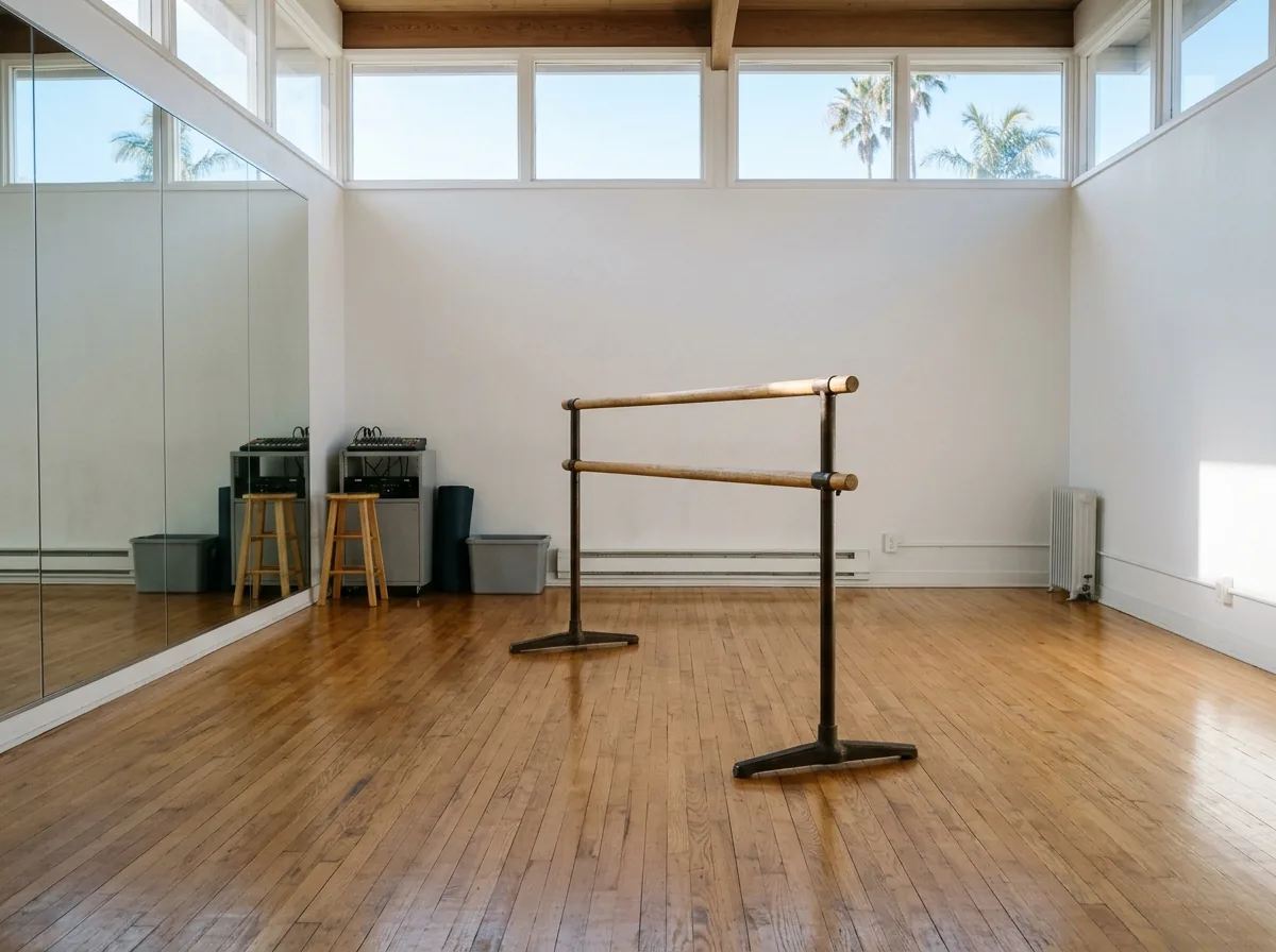 Small dance studio with a satin maple floor and a portable ballet barre